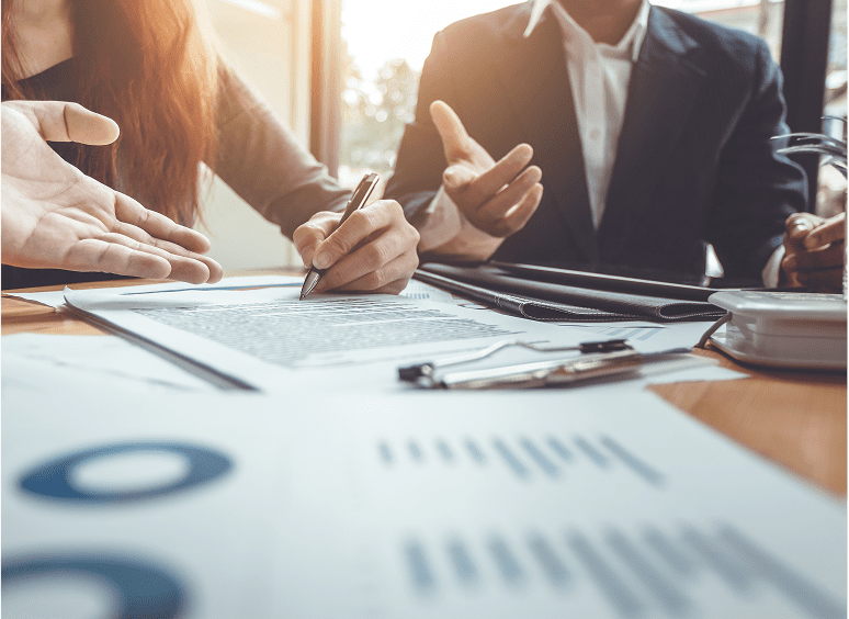 Team collaborating on paperwork and decisions